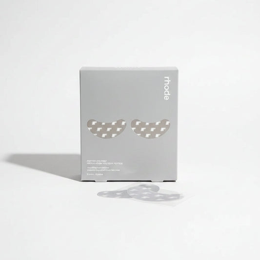 Two eye patches on a wooden surface with a box labeled 'rhode' in the background.