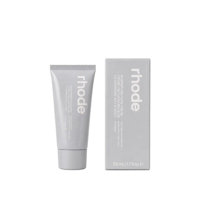 Gray tube and box of 'rhode' skincare product on a white background