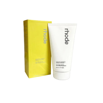 Tube of 'rhode' product next to its packaging on a white background