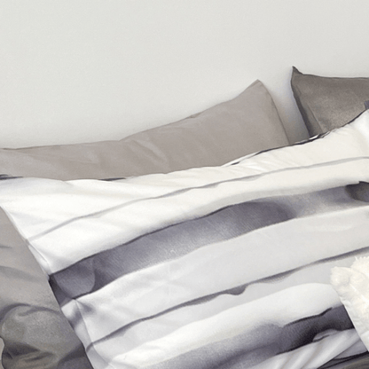 Single size, 4-piece, reversible duvet cover set featuring a striped design in a vibrant gray color.